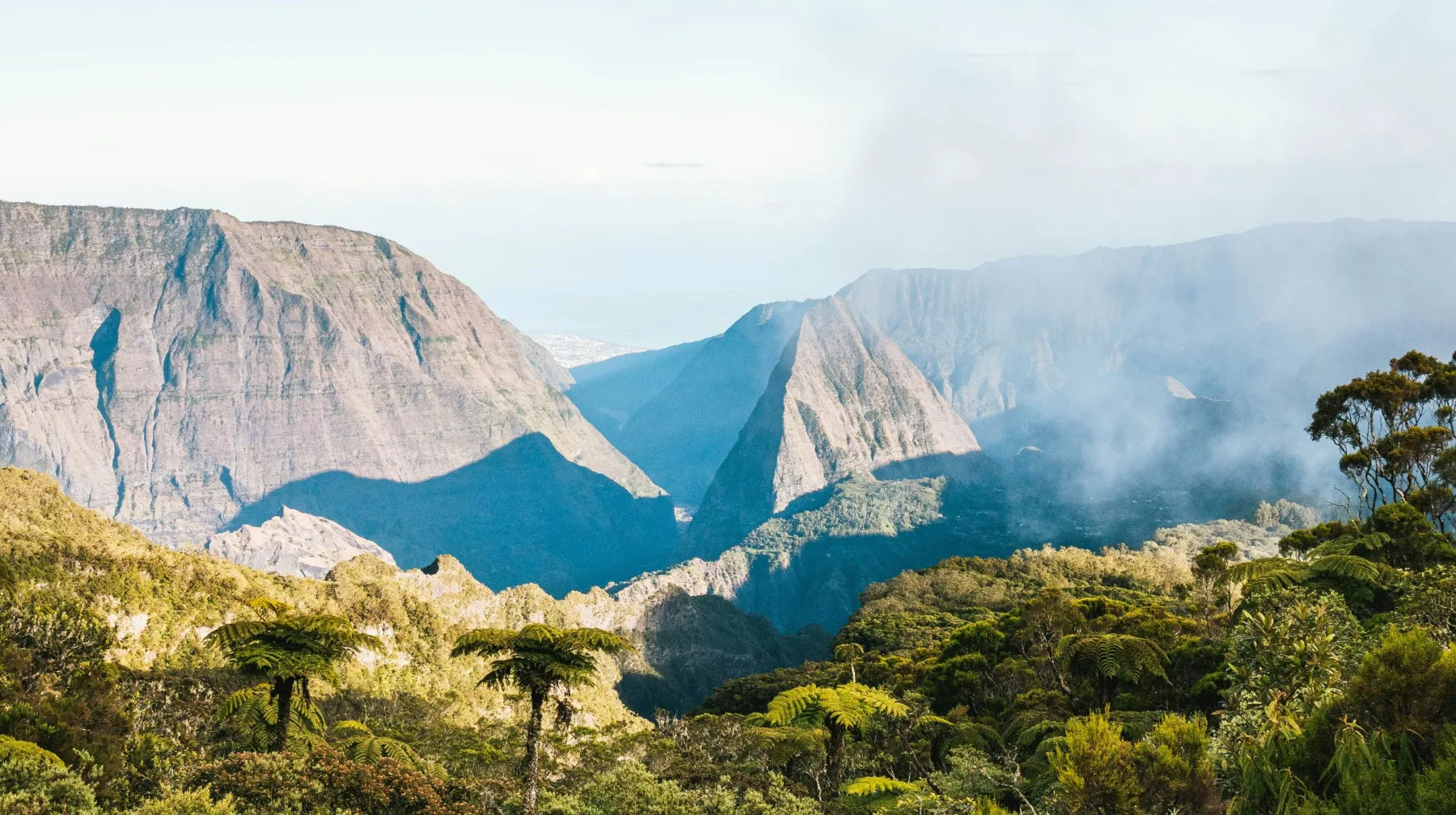 Paysages majestueux et luxuriants, montagnes impressionnantes et végétation dense d'un lieu préservé.