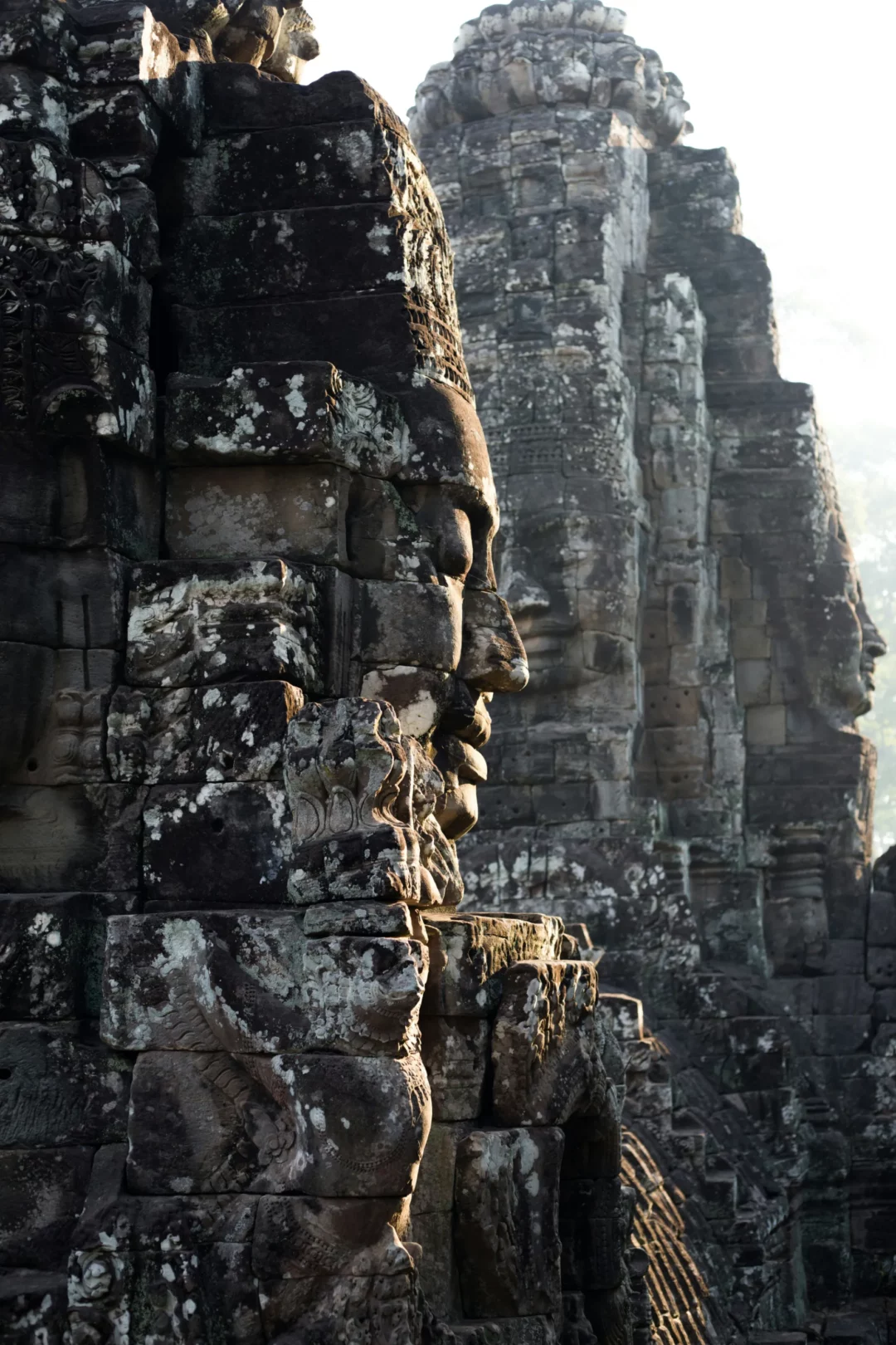 Angkor Thom, Cambodge — visages sculptés majestueux dans la lumière douce du matin.